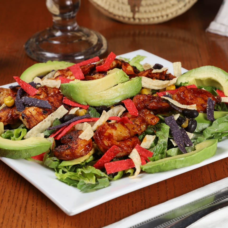 La Fuente Mexican Bar & Grill's vibrant salad with grilled chicken, avocado, black beans, and tortilla strips.